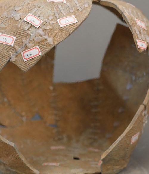 Ceramic vessel being reassembled during cultural relic restoration practice